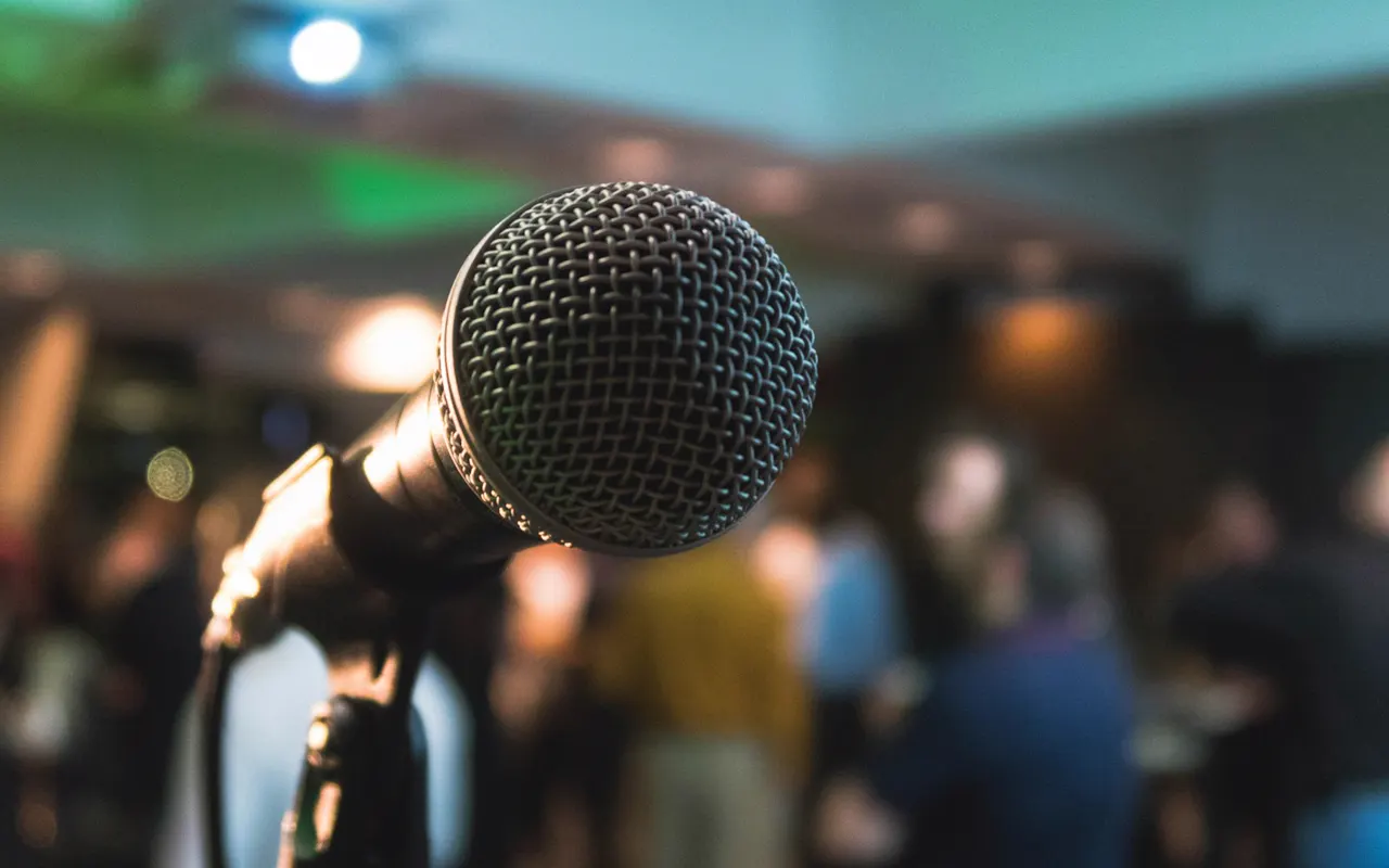 Speaker addressing an audience from a stage