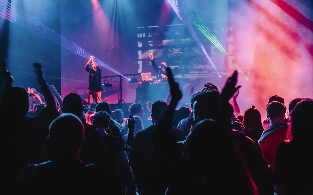 Singer performing on a large stage under concert lights
